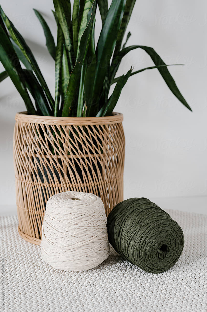 Bobbins of threads and wicker basket with plants