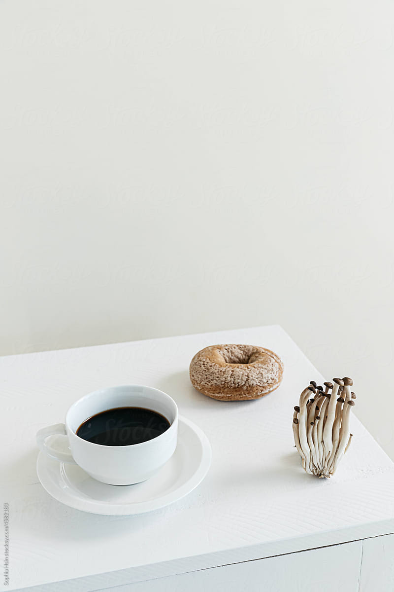 Coffee cup, bagel and mushroom