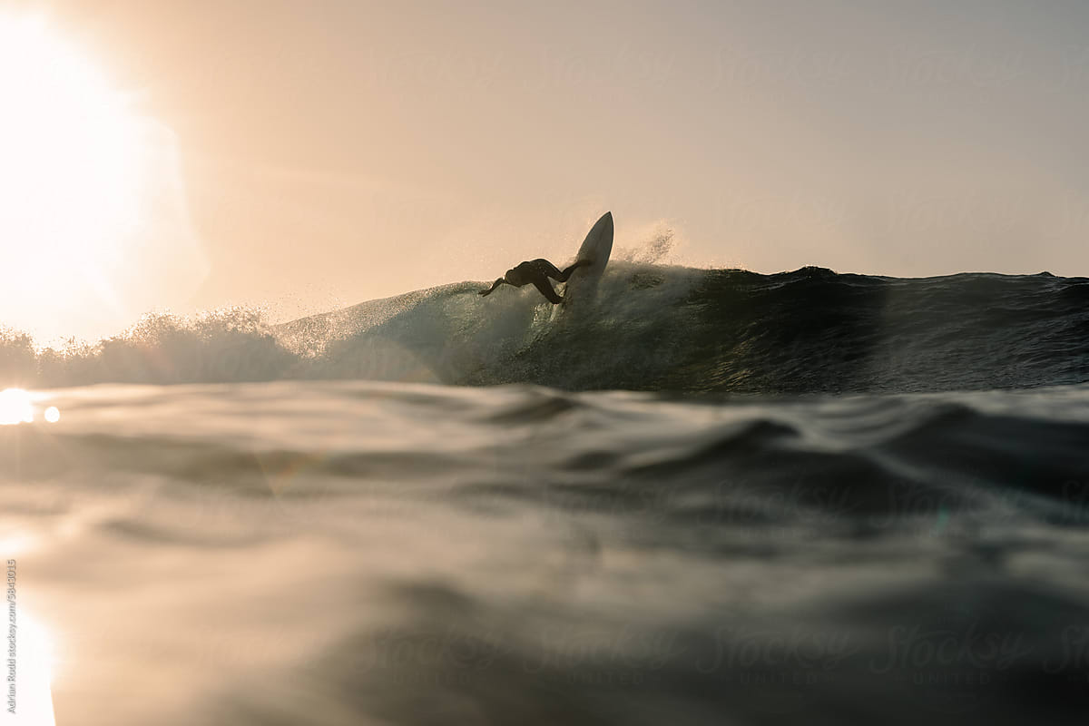 A professional surfer executing a reentry while riding a wave