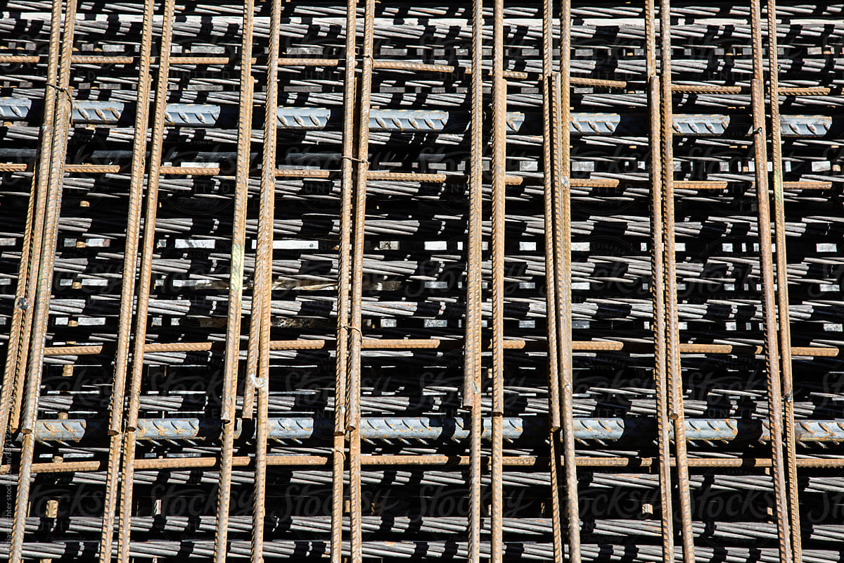 Grid of Metal Rods Creating Shadow Patterns at Construction Site