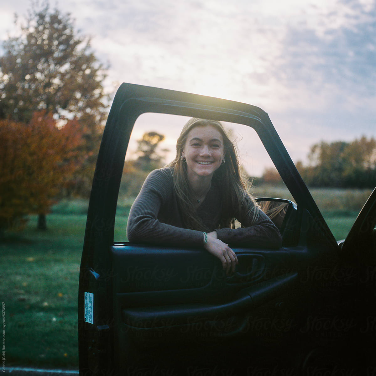 Smiling teenage by her truck