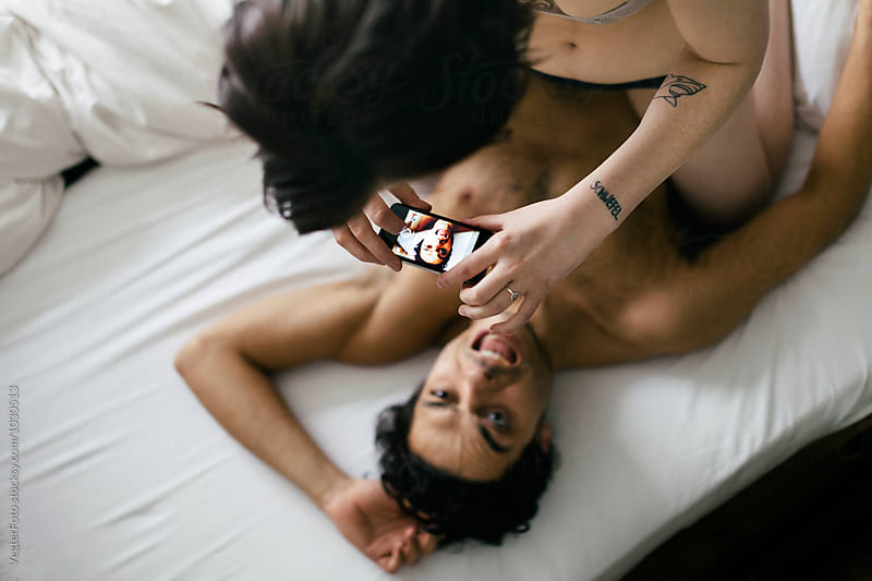 Couple in Bed taking Selfie