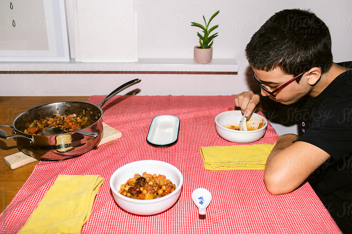 Teenager having dinner at home