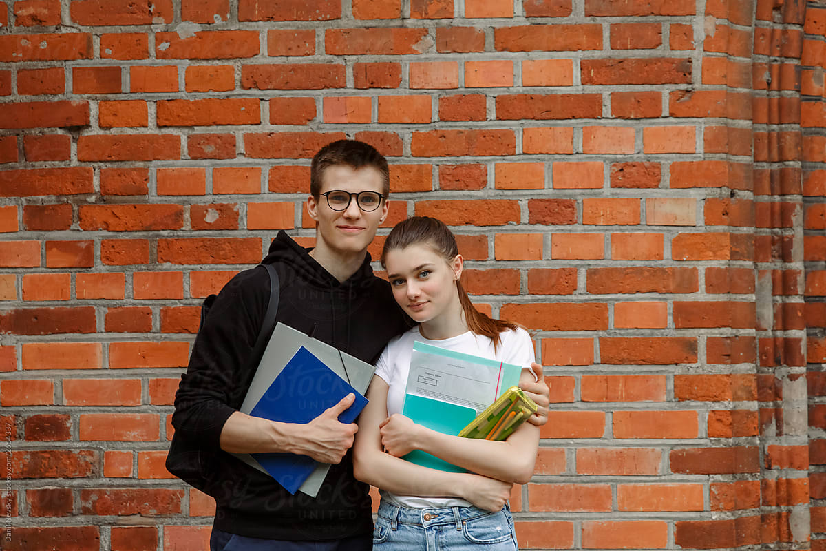 Positive students with copybooks at campus