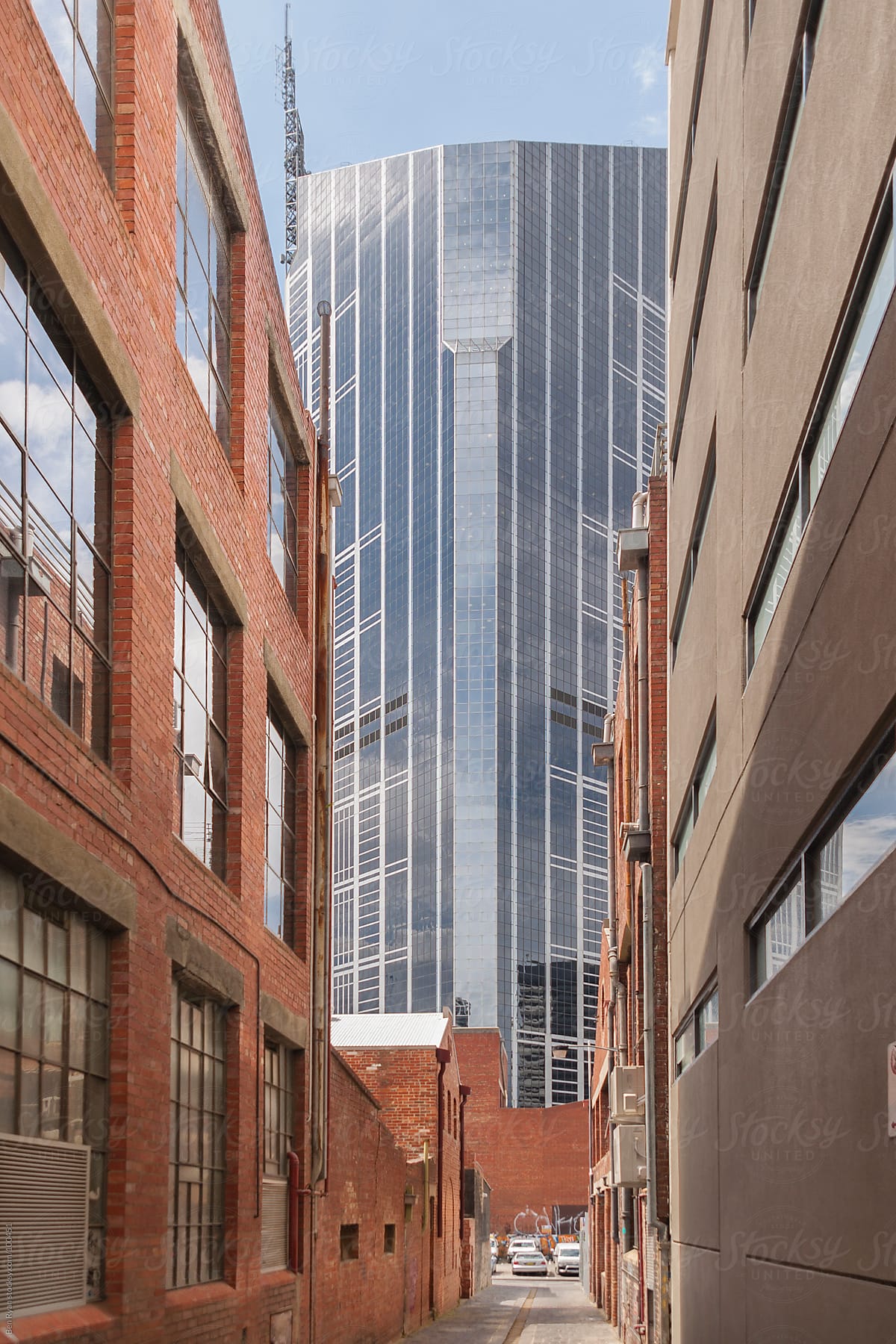 View down an historic alley to a modern skyscraper