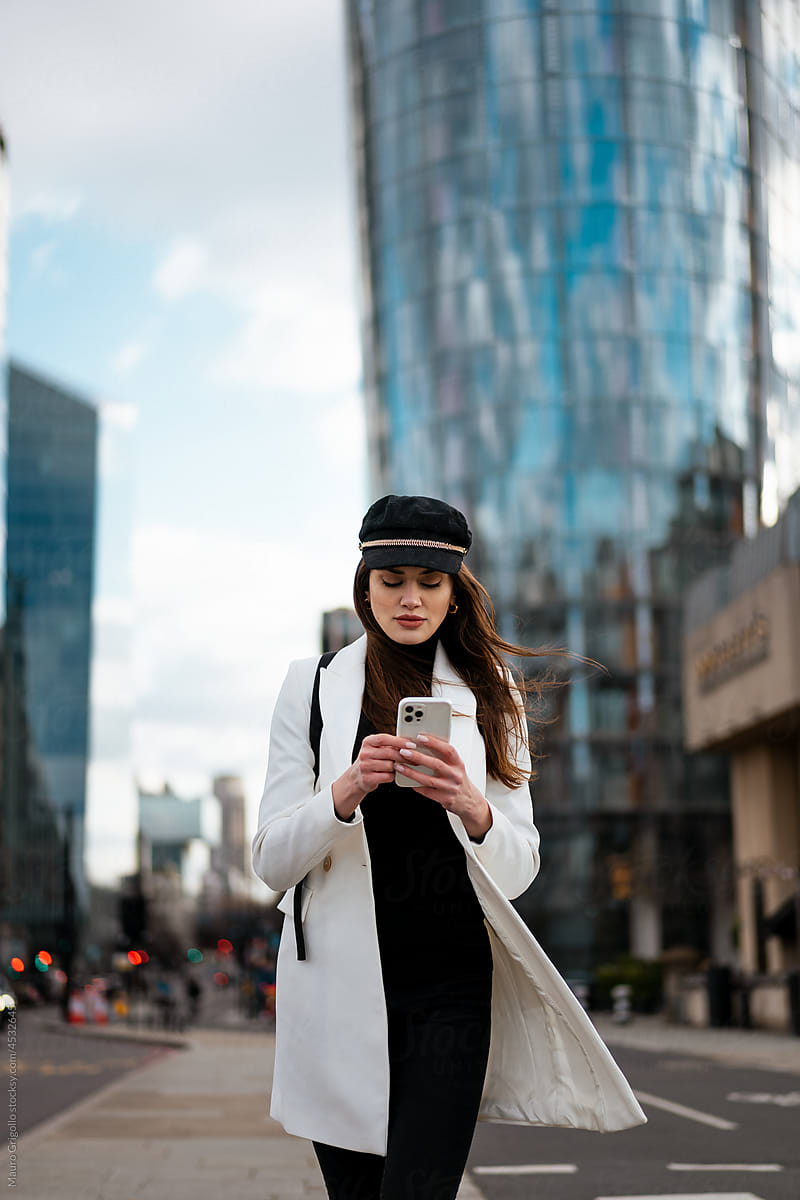 Elegant woman in the city using a mobile phone