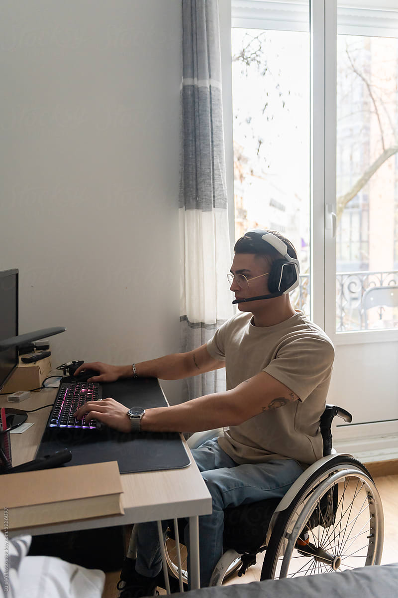 Young Adult Wheelchair User Using A Desktop Computer