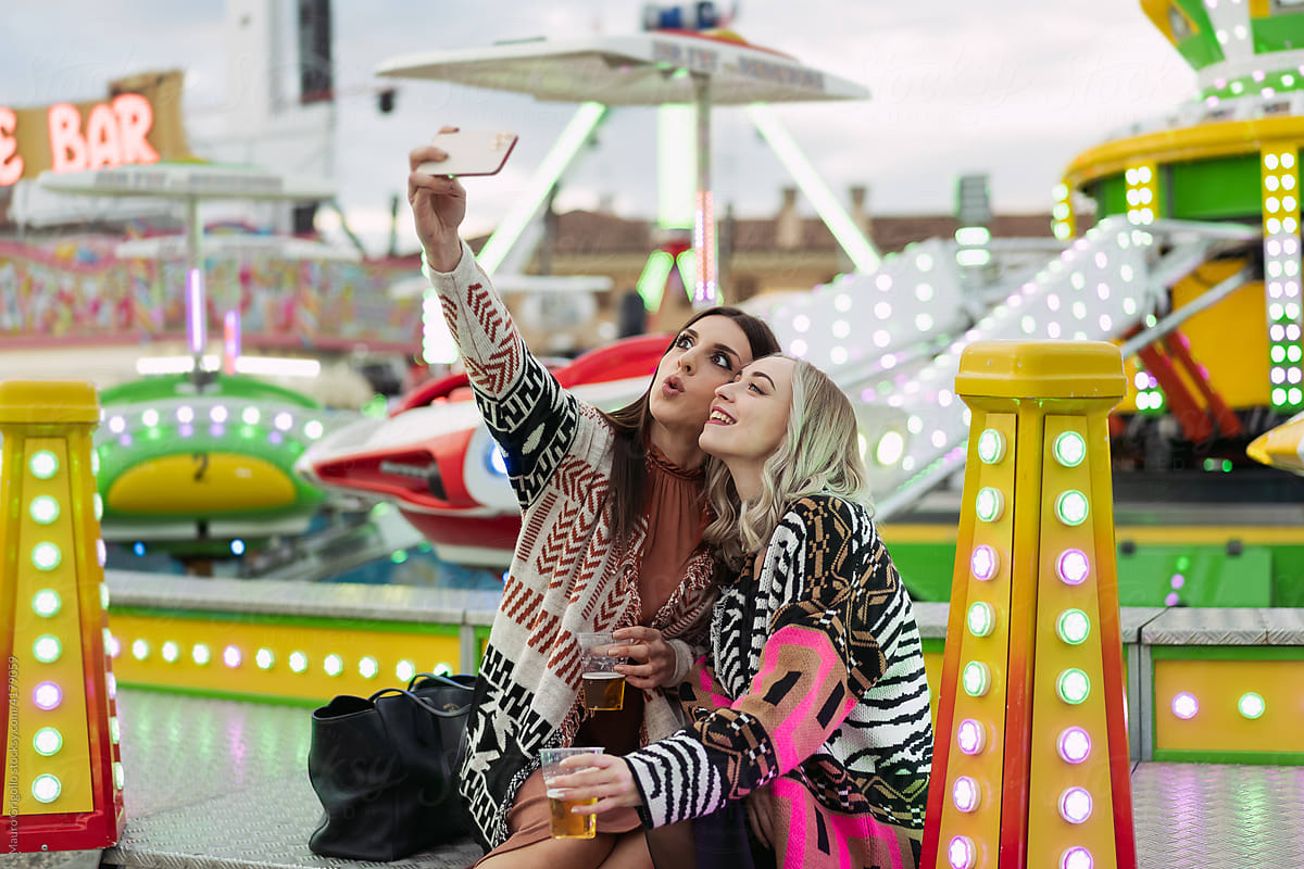 Funny women taking a selfie on rides