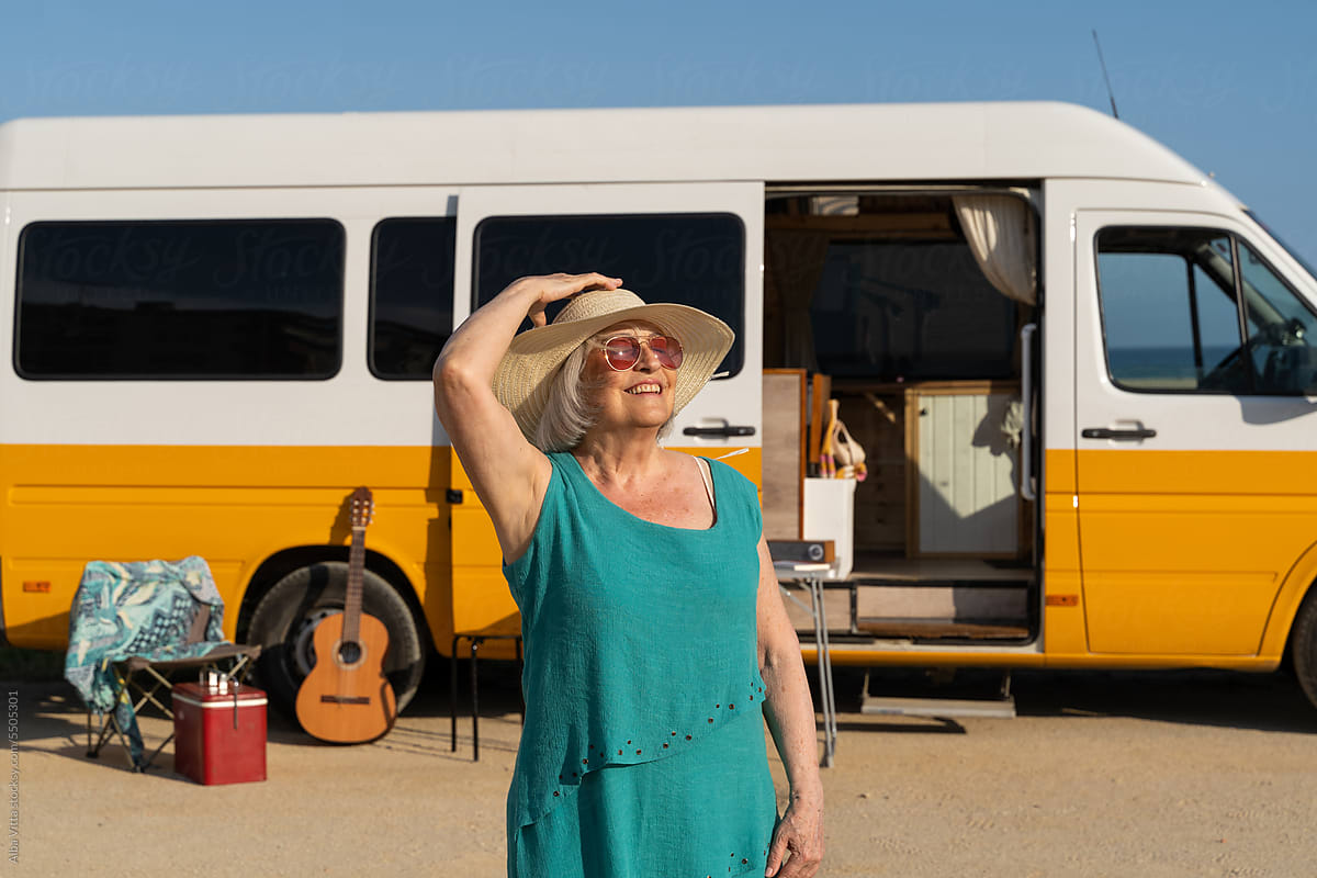Happy retired woman in camper van