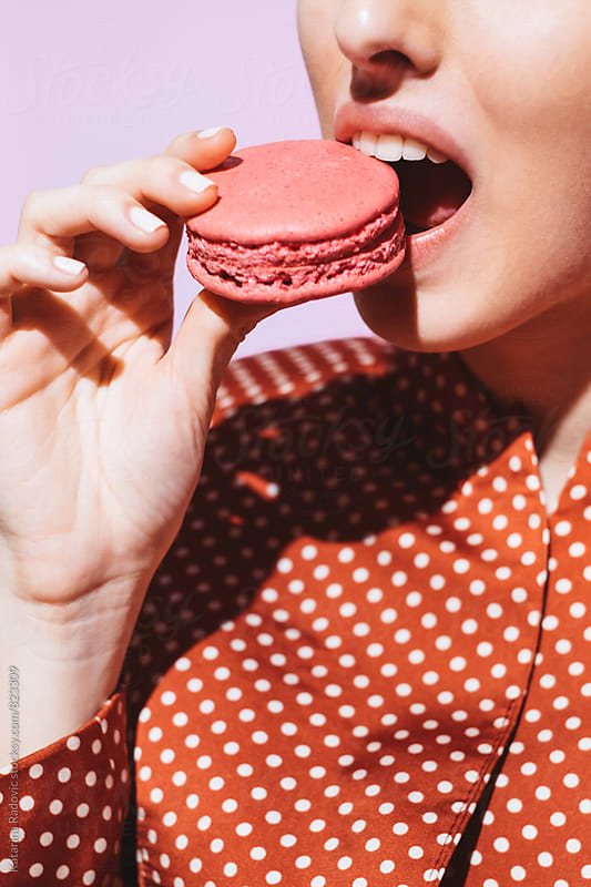 Sensual Woman Eating Pink Macaron