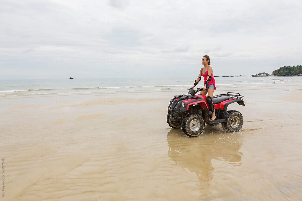 an asian woman driving an ATV