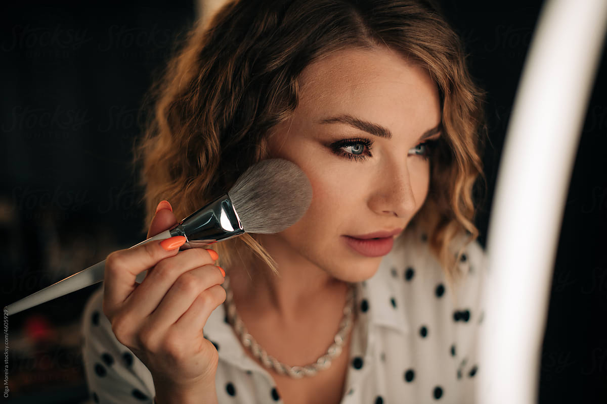 Close up shot of a woman applying make up