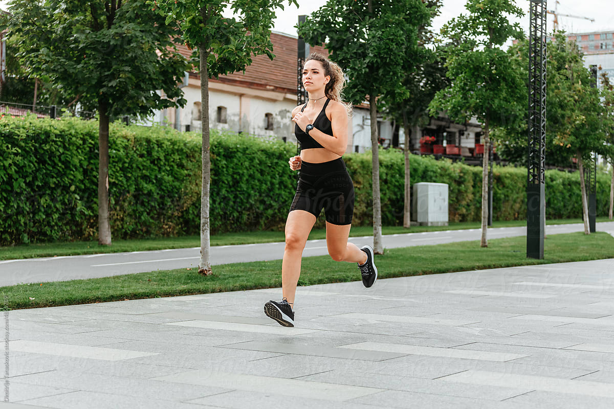 Woman Running In Neighbourhood.