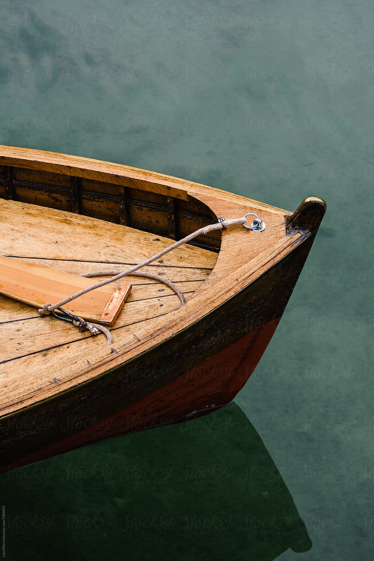 Closeup of the prow of a wooden boat in lake