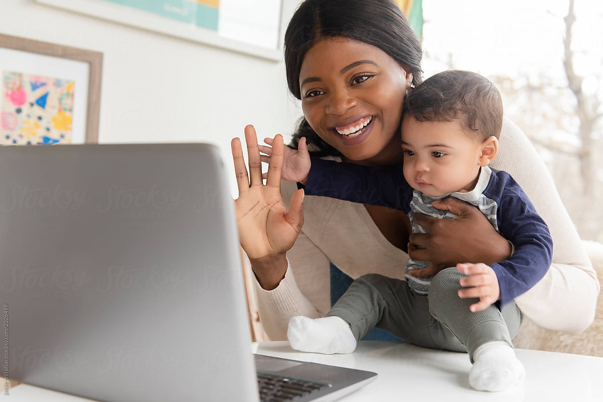 Mother and baby waving to laptop
