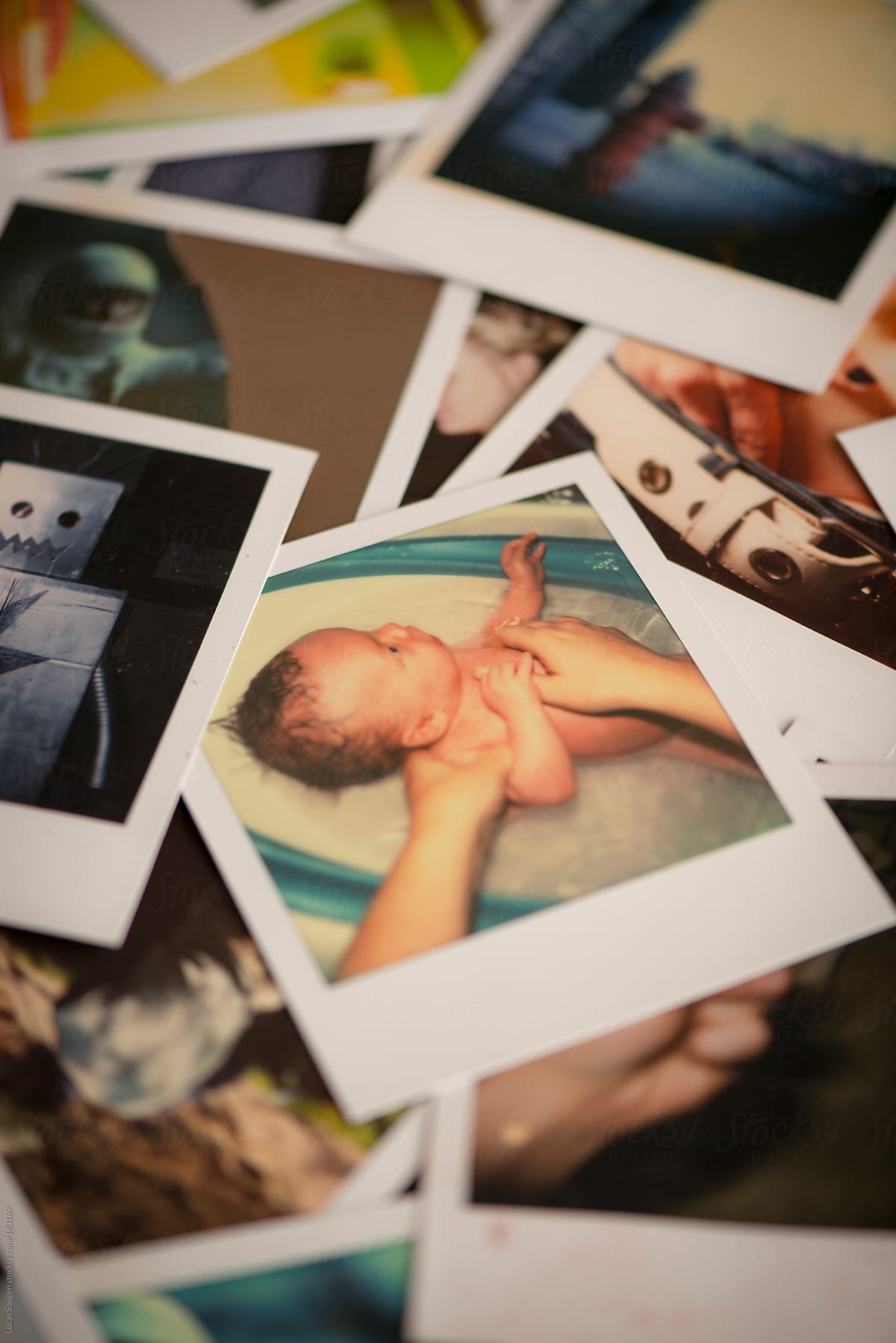 Polaroid of a newborn baby boy taking a bath.