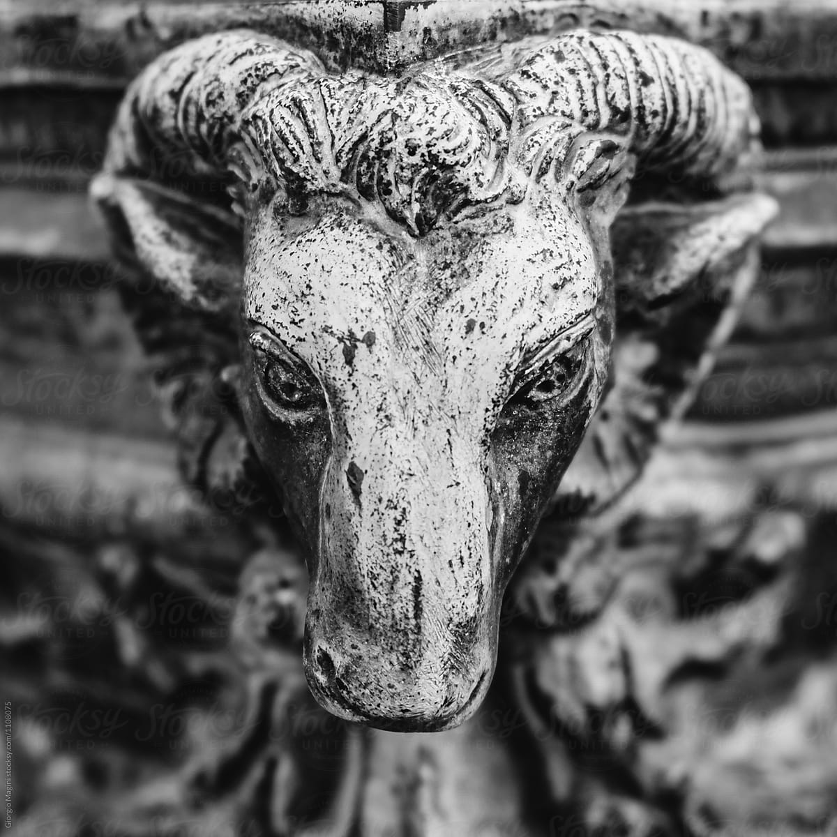 Copper Statue of a Goat\'s Head in an Old Cemetery