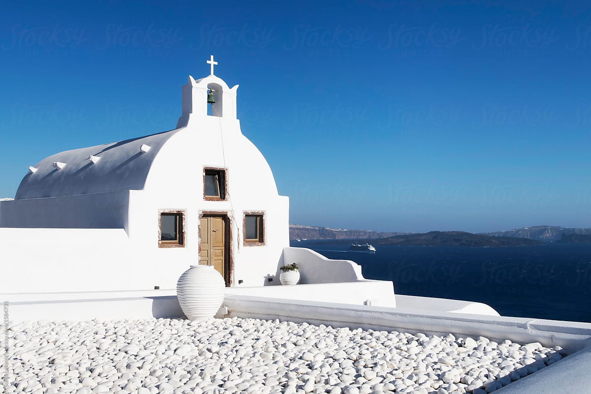 greek white church, blue sky and sea postcard landscape