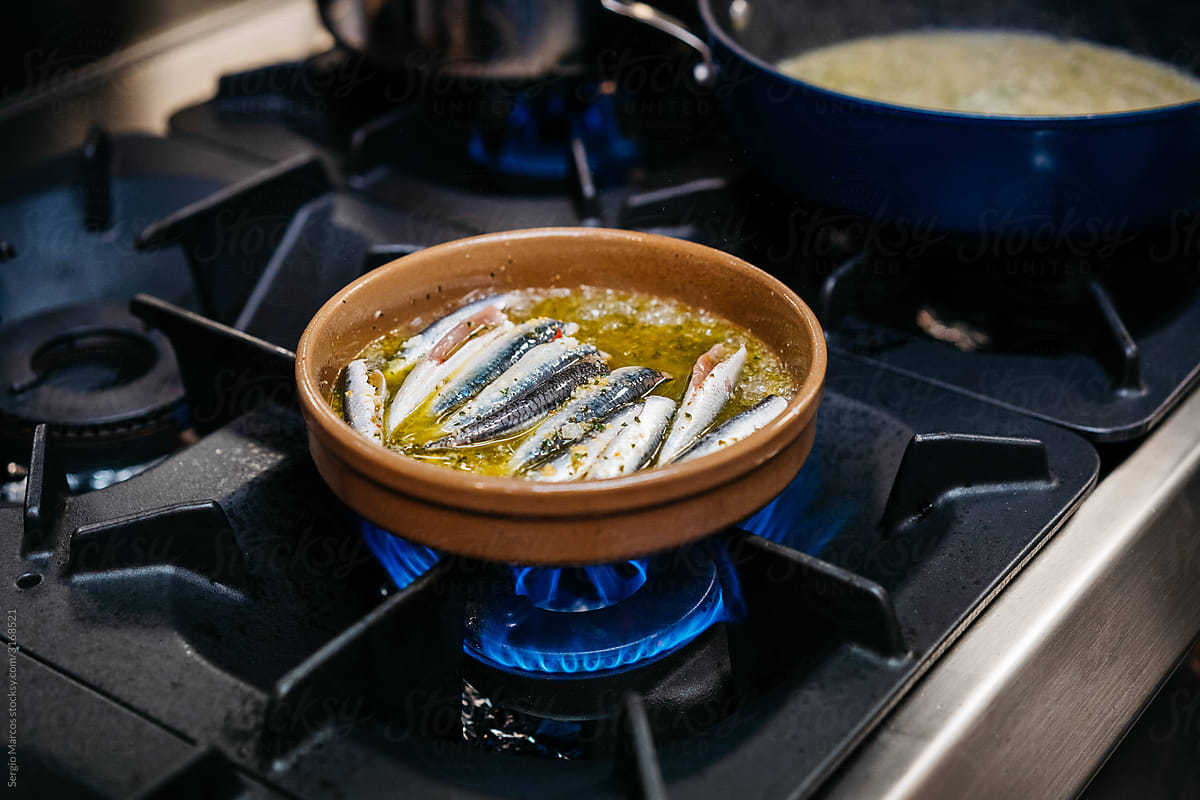 Sardines dish being cooked in earthenware dish