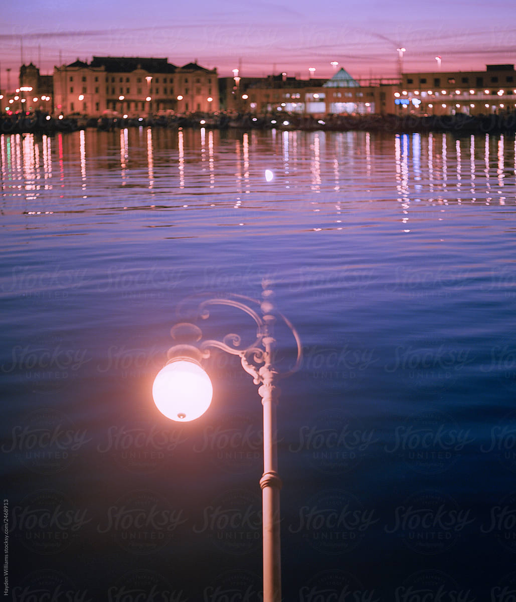 Night City over water behind street lamp