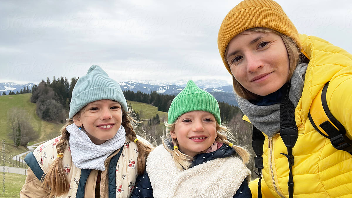 Selfie of a mother with her daughters in the mountains