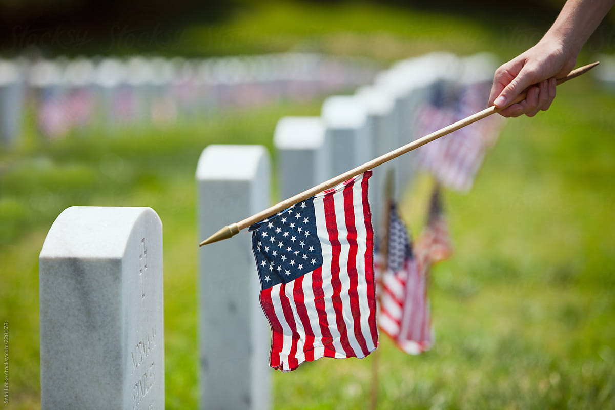 Memorial: Boy Placing American Flags By Headstones