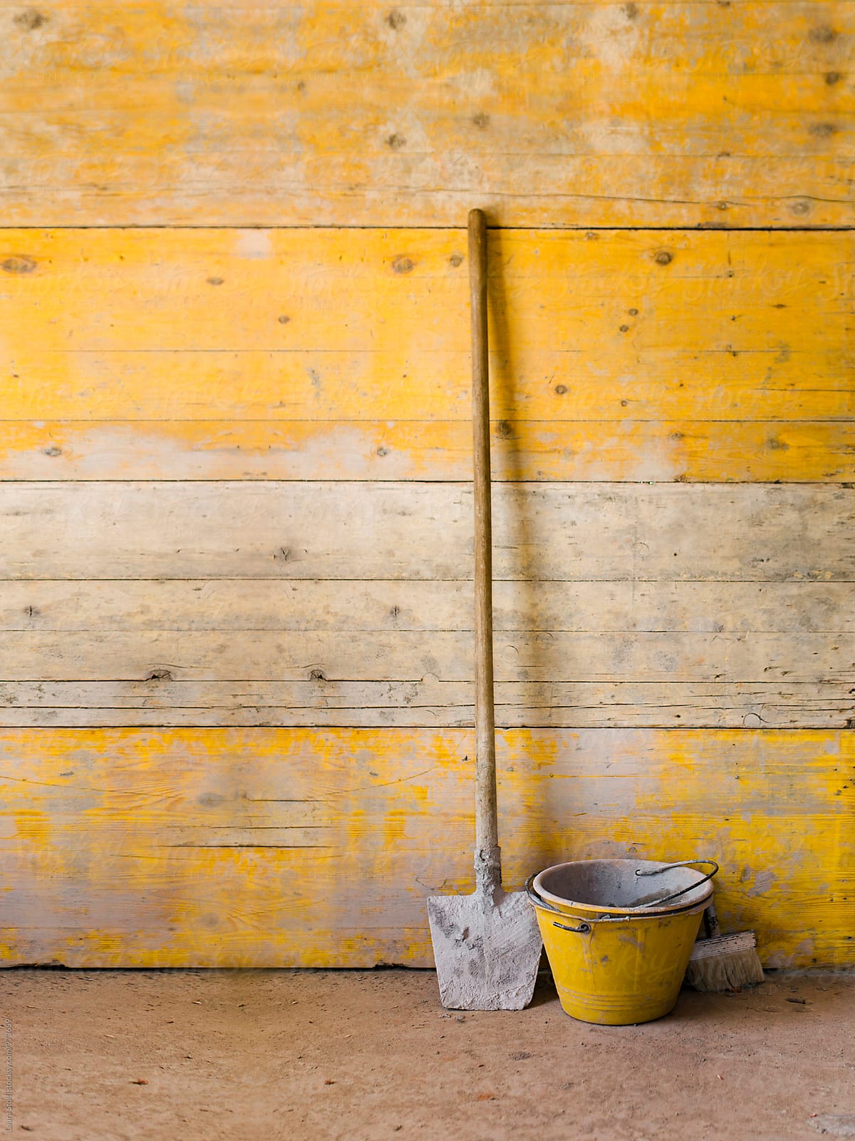 Working carpenter's tools in front of temporary wooden yellow wall