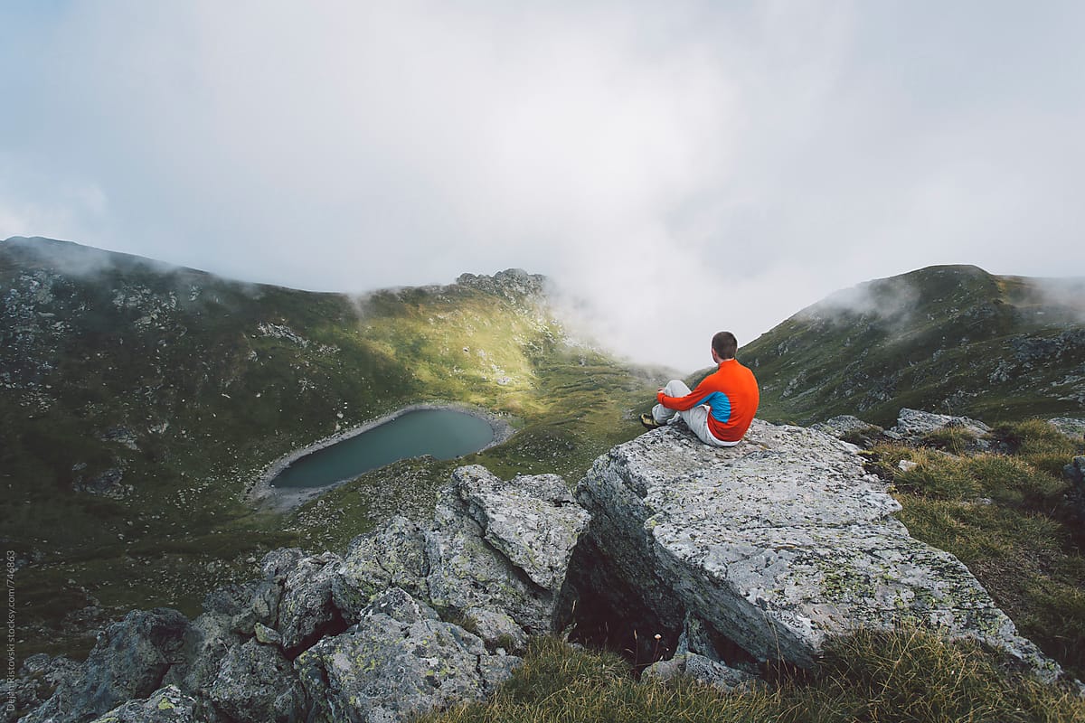 Hiker On Peak On A Beautiful Mountain Range by Dejan Ristovski