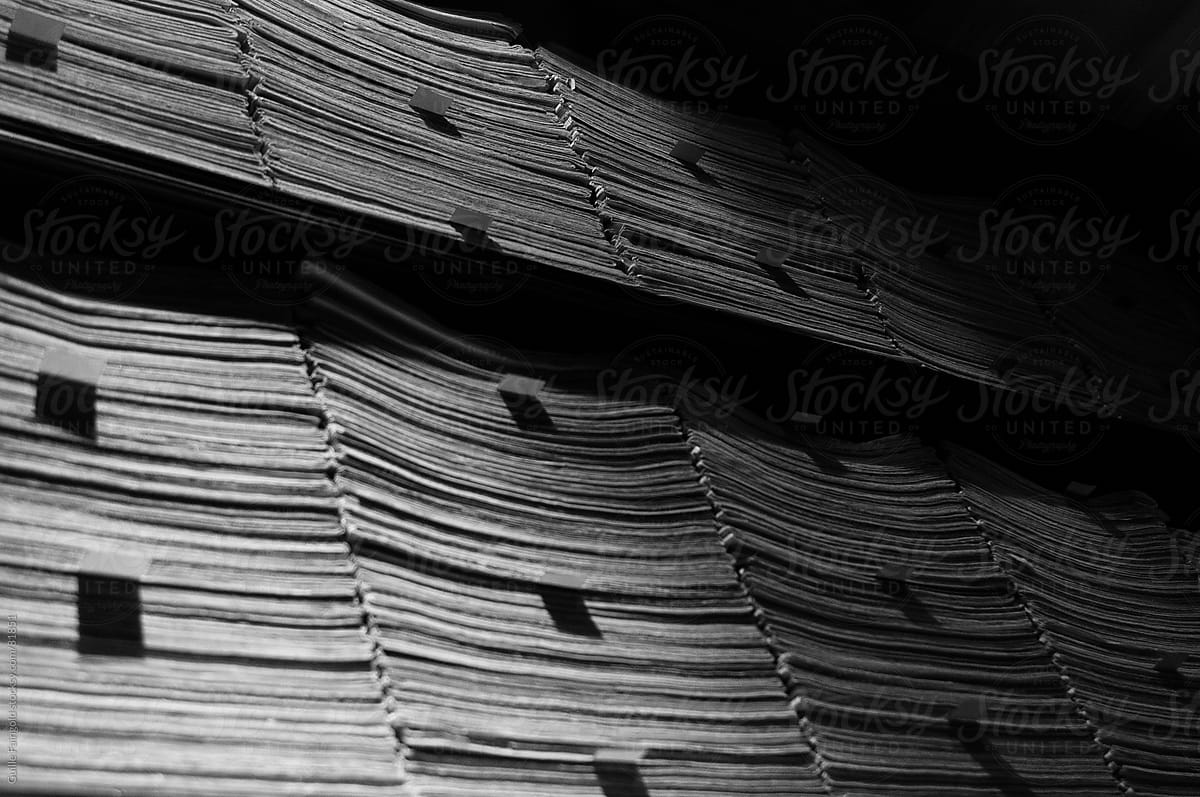 Stacked archived papers on shelves