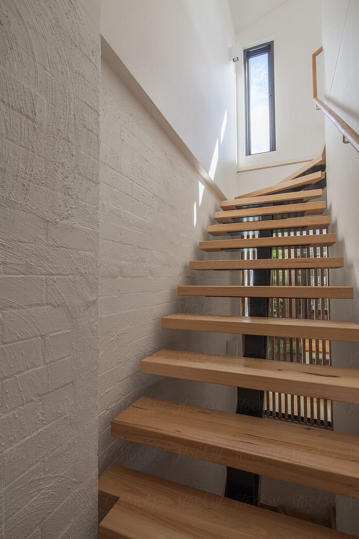 Timber staircase to upper levels of converted warehouse apartment