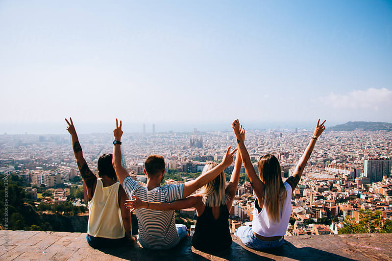 Group of friends sitting in a lookout with the city at your feet