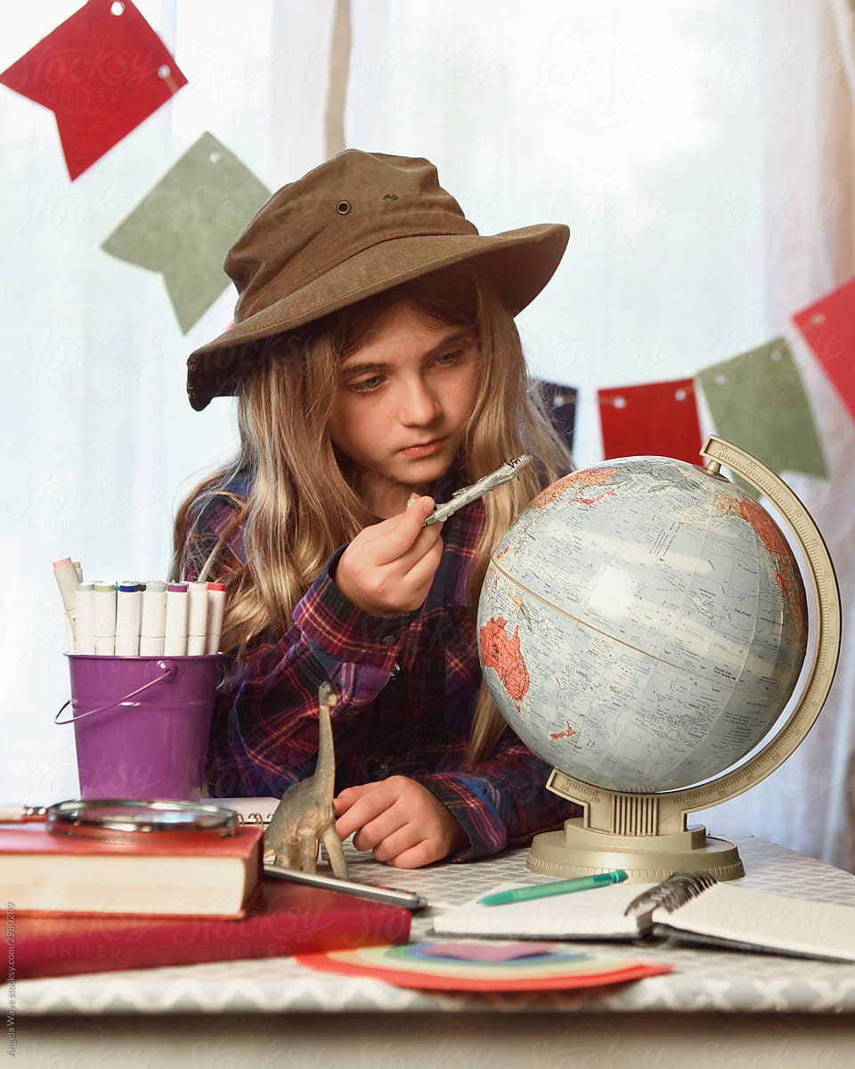 Travel Student Looking at Globe with Airplane