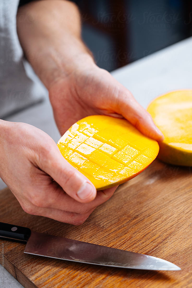 Chef cutting mango