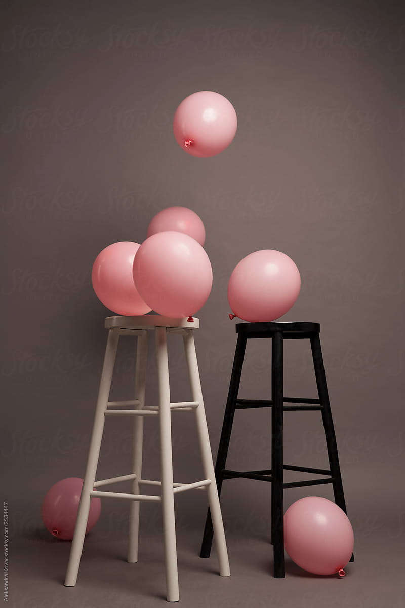 Party Pink Balloons and chairs on grey Background
