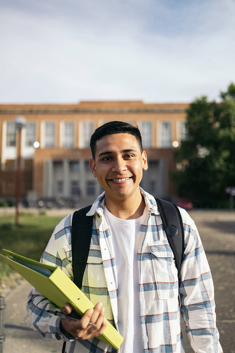 Portrait of a smiling young Latin American student on campus