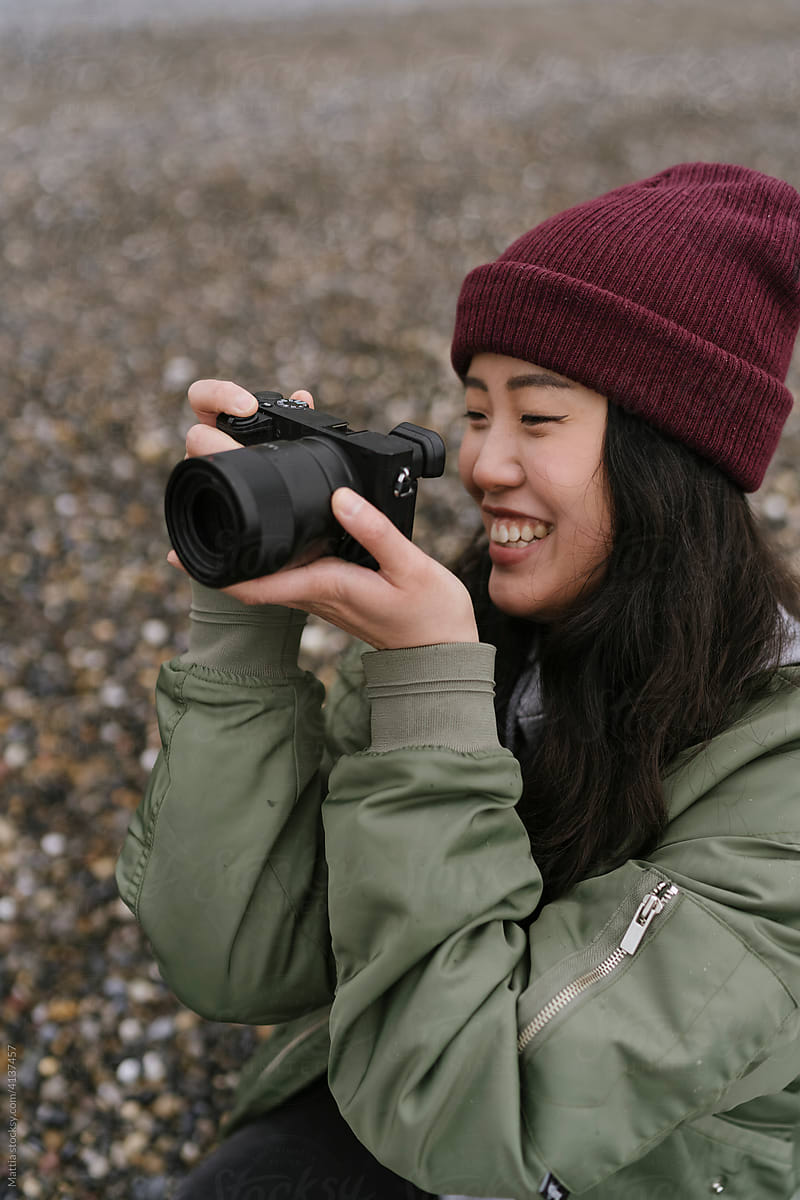 Young Asian Female Photographer on the Beach
