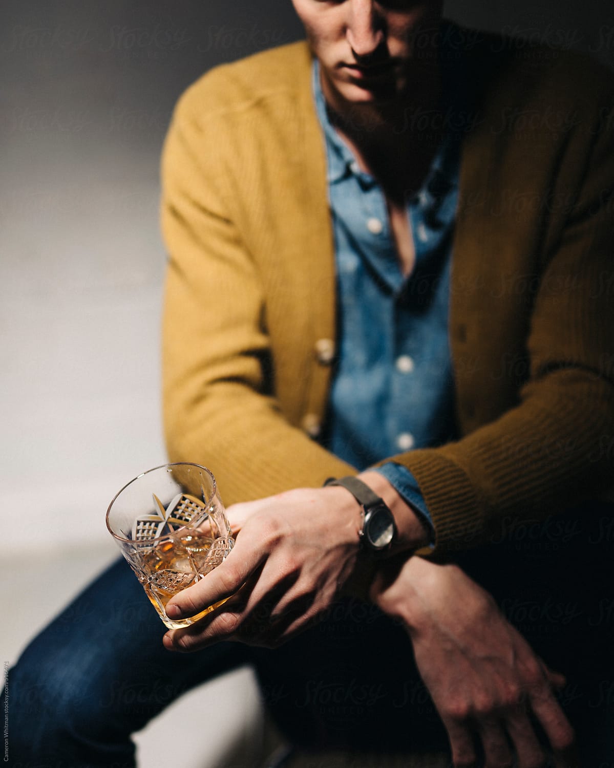 Somber man with a glass of whiskey
