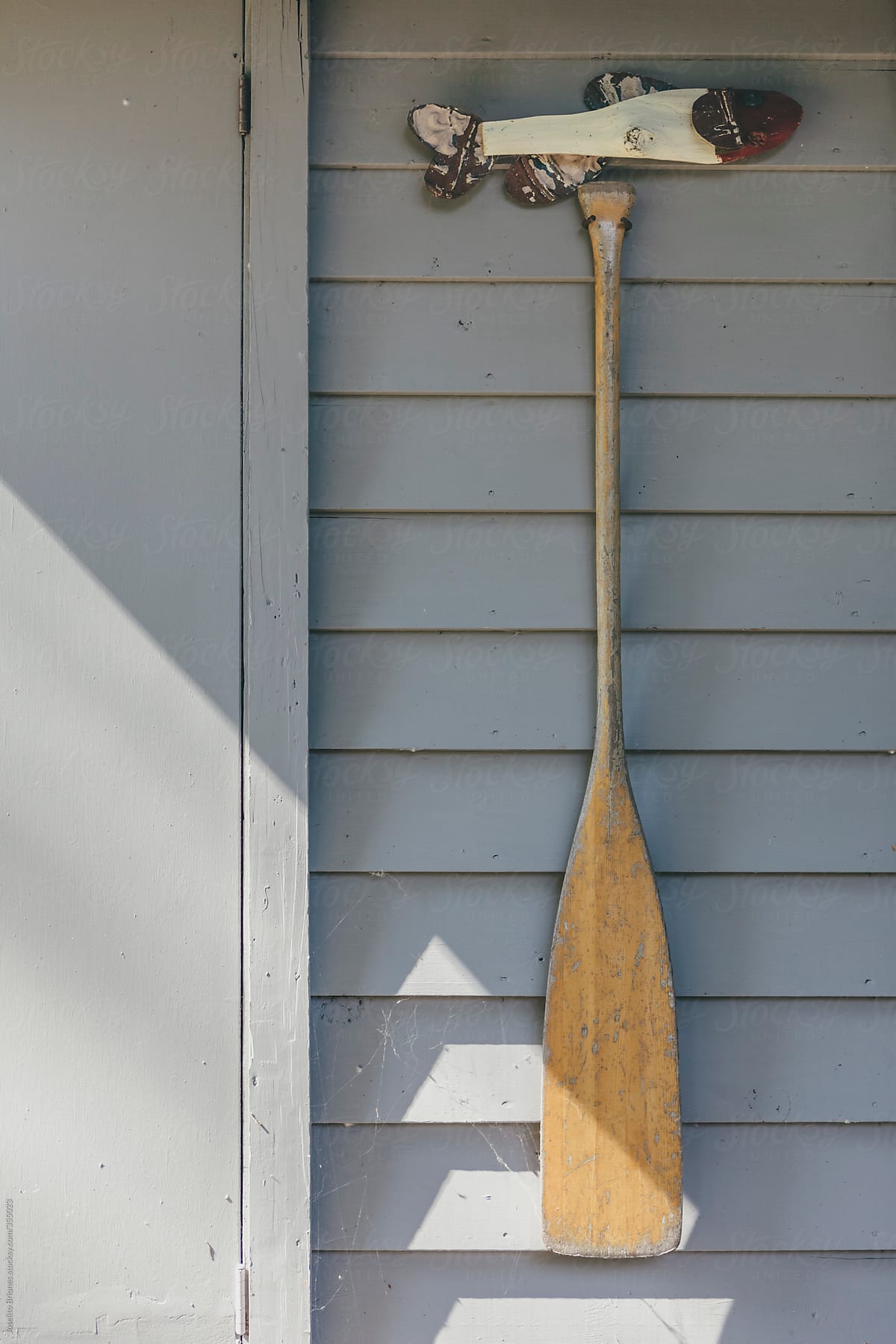 Wooden Fish and Paddle as Rustic Home Decoration in Nautical Theme on a Waterfront Country Cottage