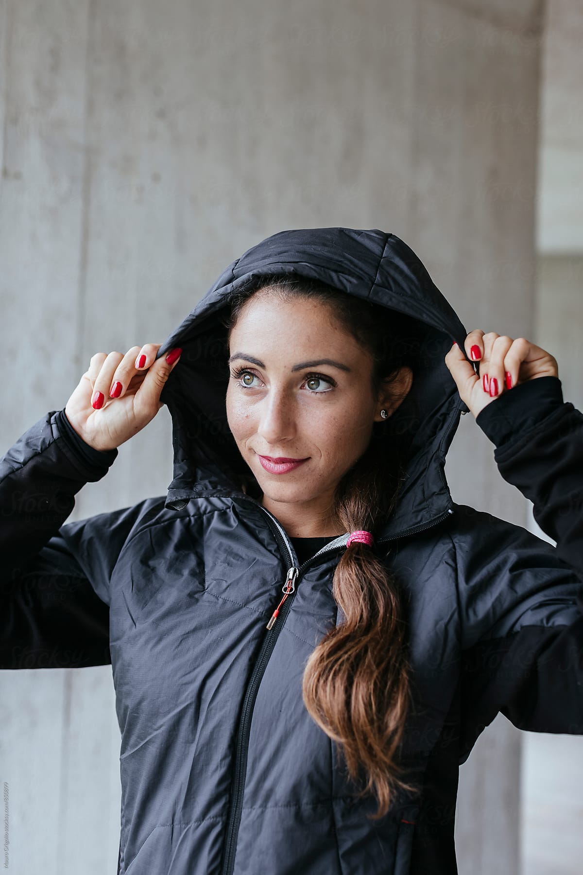 Woman puts on a rain jacket to go out