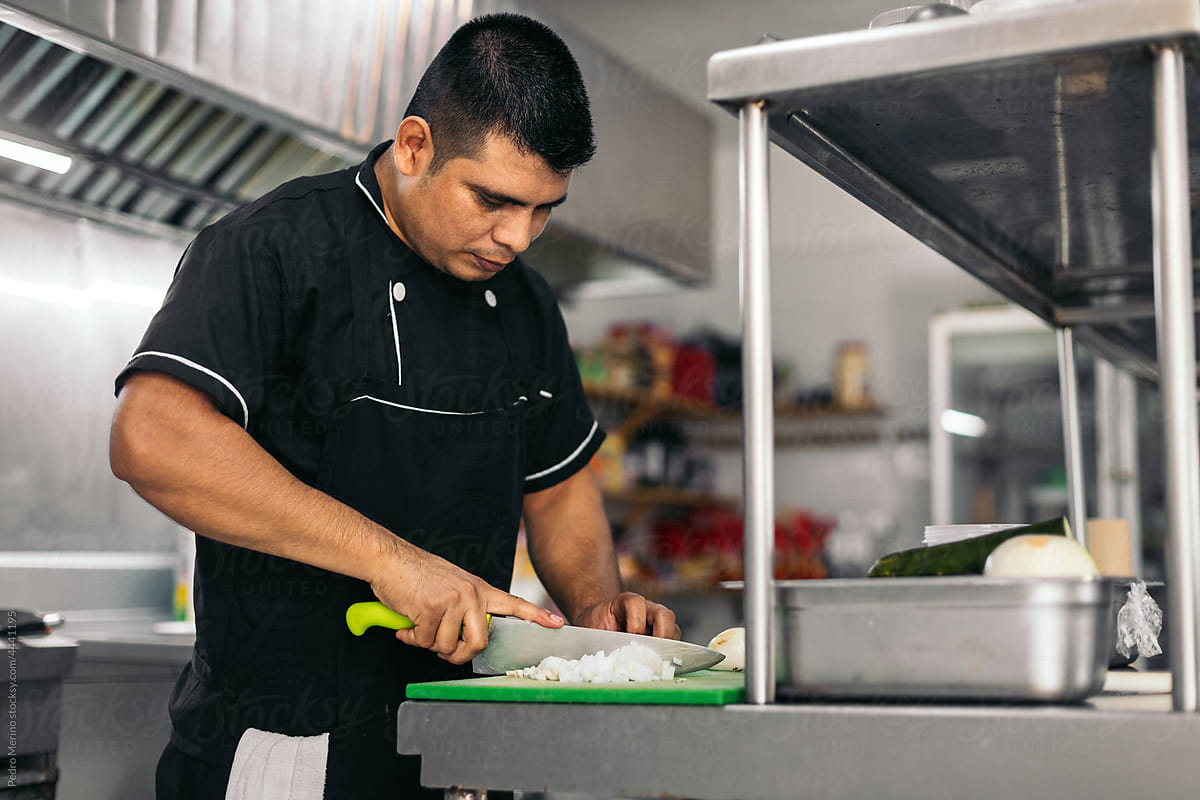 Hispanic chef cutting vegetables