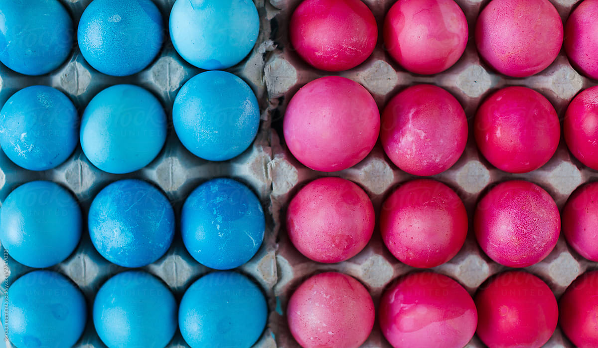 Blue and pink Easter eggs in the package on blue background.