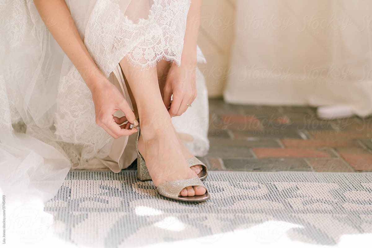bride tying her sandal
