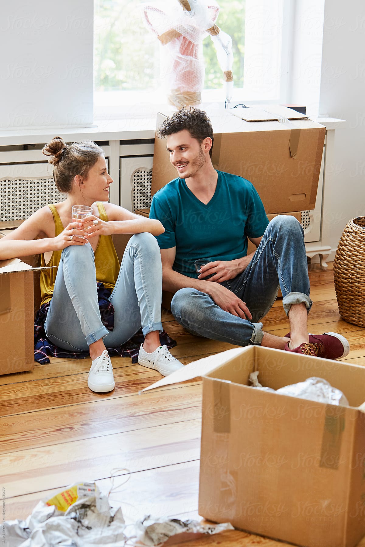 Couple Talking While Taking Break From Unpacking In House
