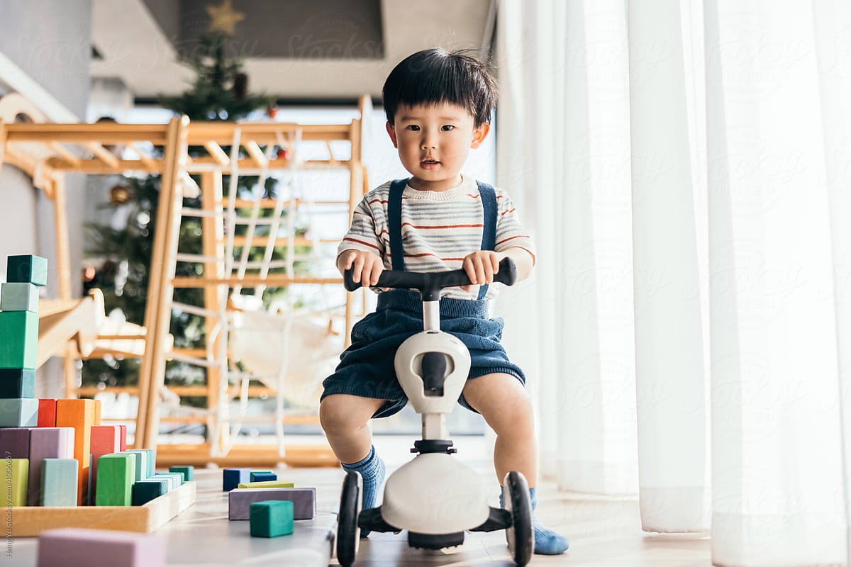 Little Boy Driving Balance Bike indoors