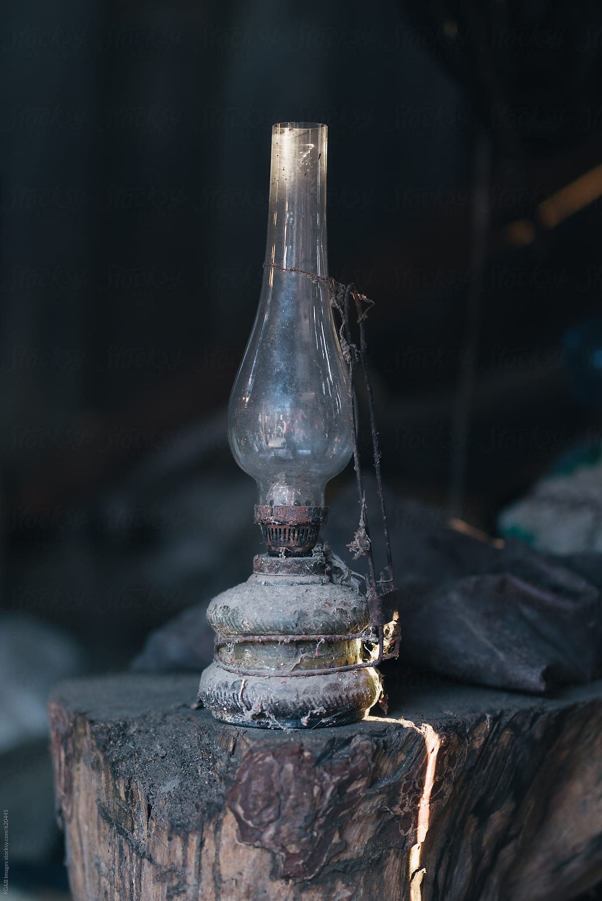 Ancient oil lamp standing on a piece of wood