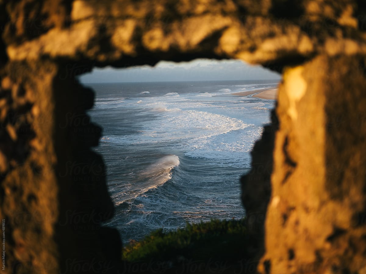 Waves in the ocean framed inside fortress window