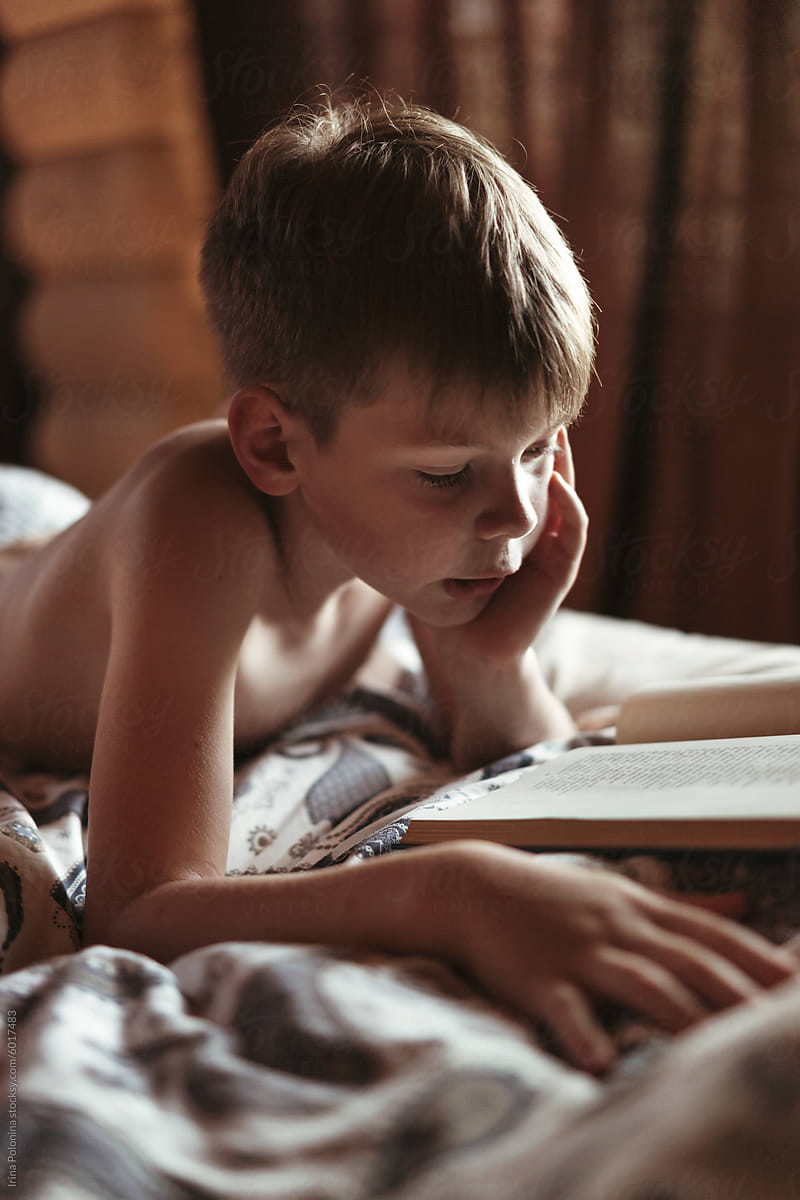 Young Boy Reading in Bed