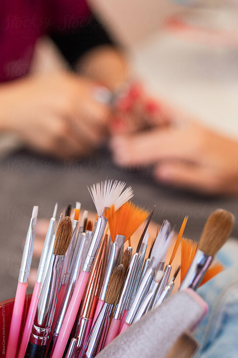 closeup of brushes of different sizes for nail painting