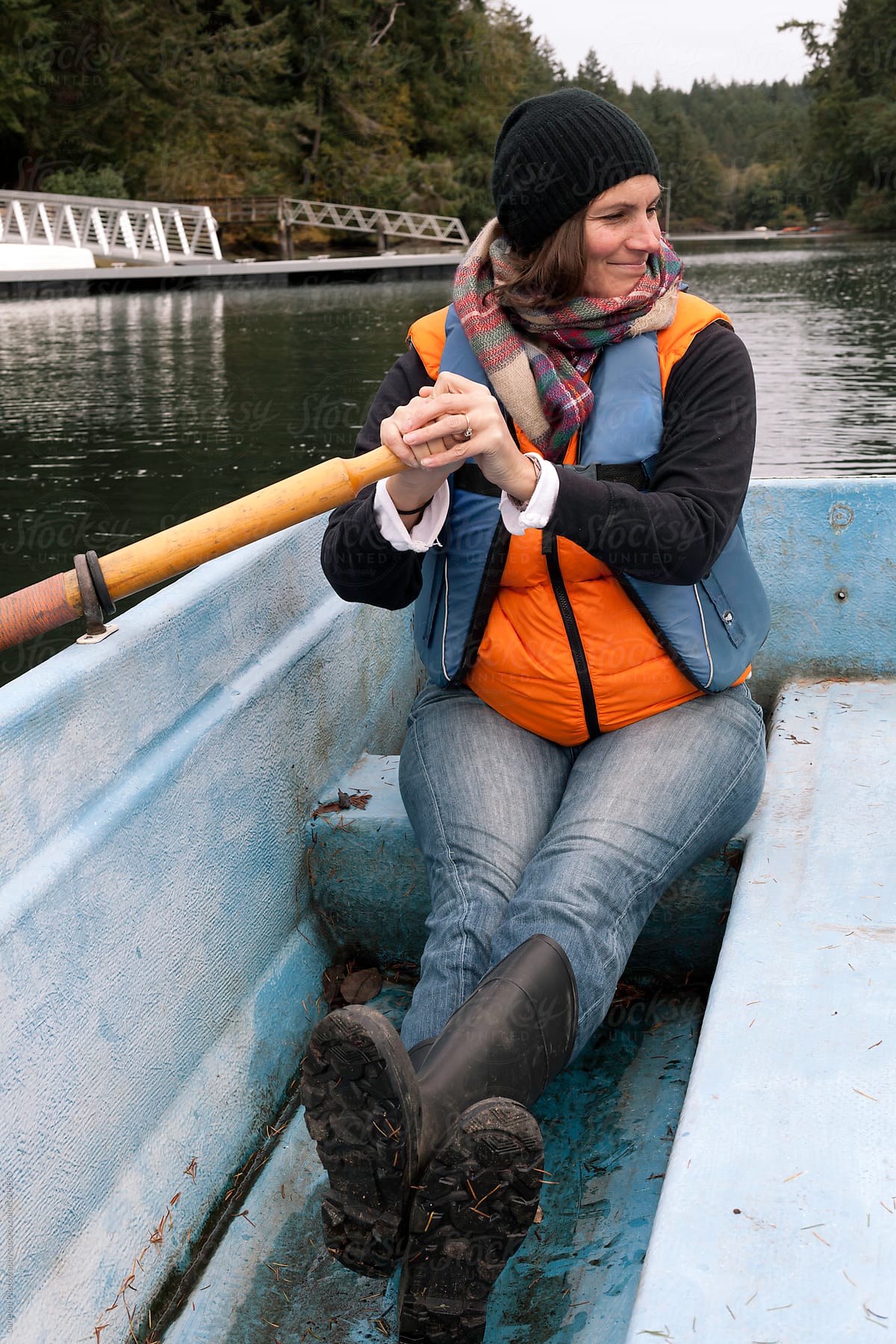 Woman in rowboat takes a break from rowing