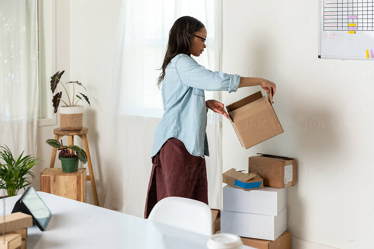 Woman Stacks Empty Boxes